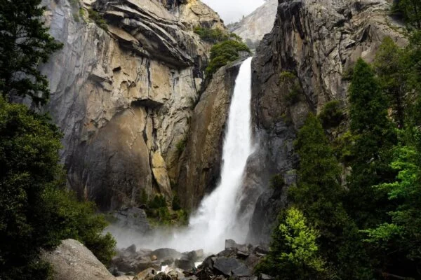 Majestic waterfall cascading down rocky cliffs, nature inspiration for NYC web design.